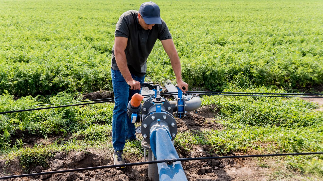 expert maintenance at the carrot field conducting commercial irrigation maintenance