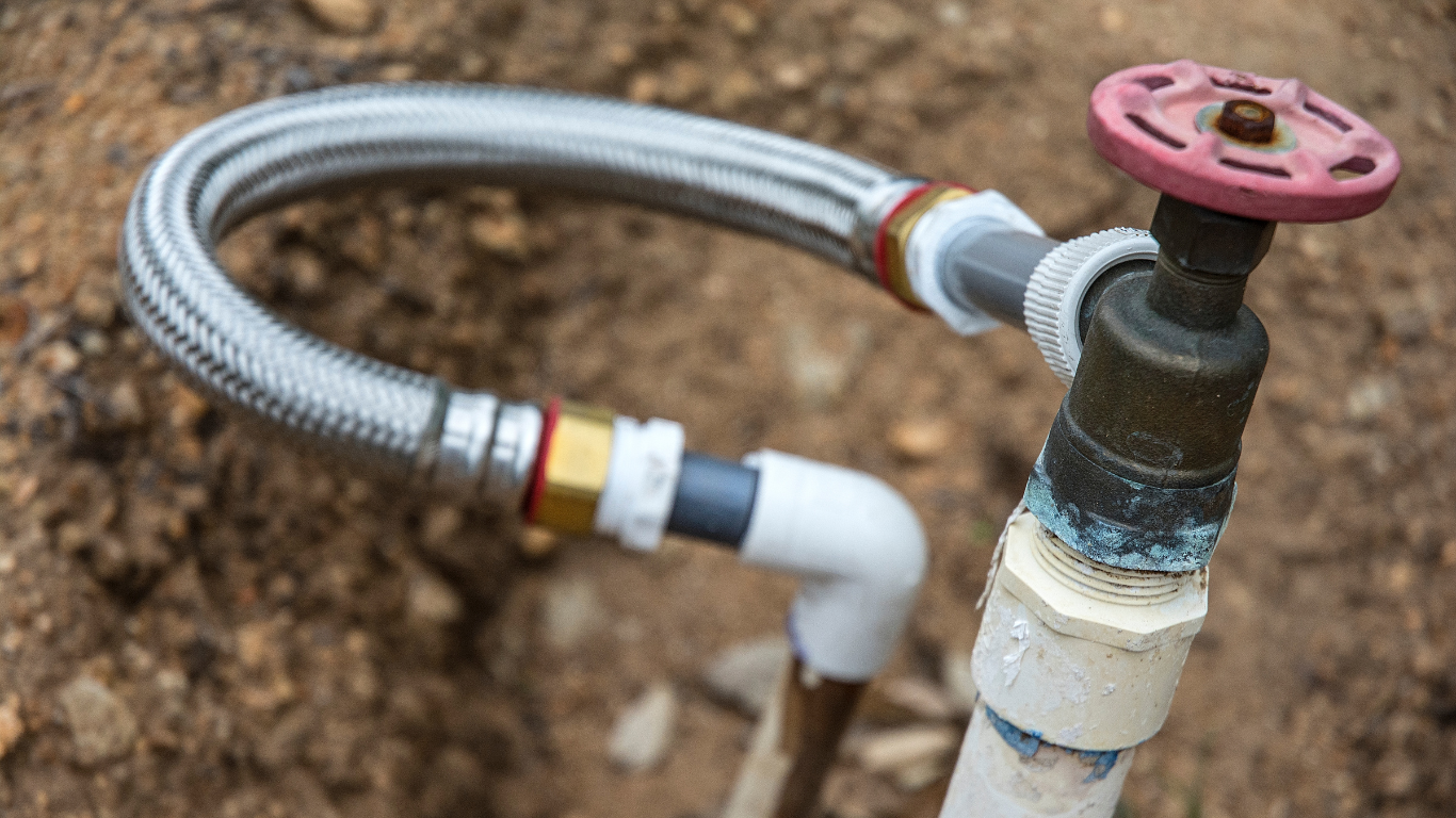 Irrigation system spigot and hose setup for valve maintenance.